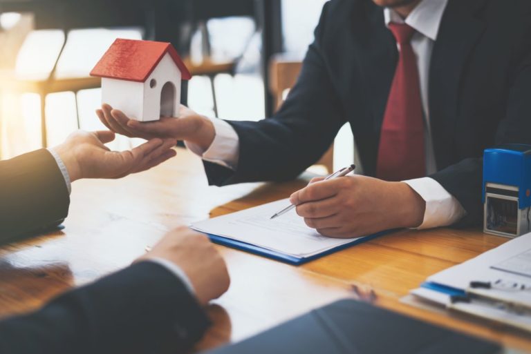 man handing miniature house