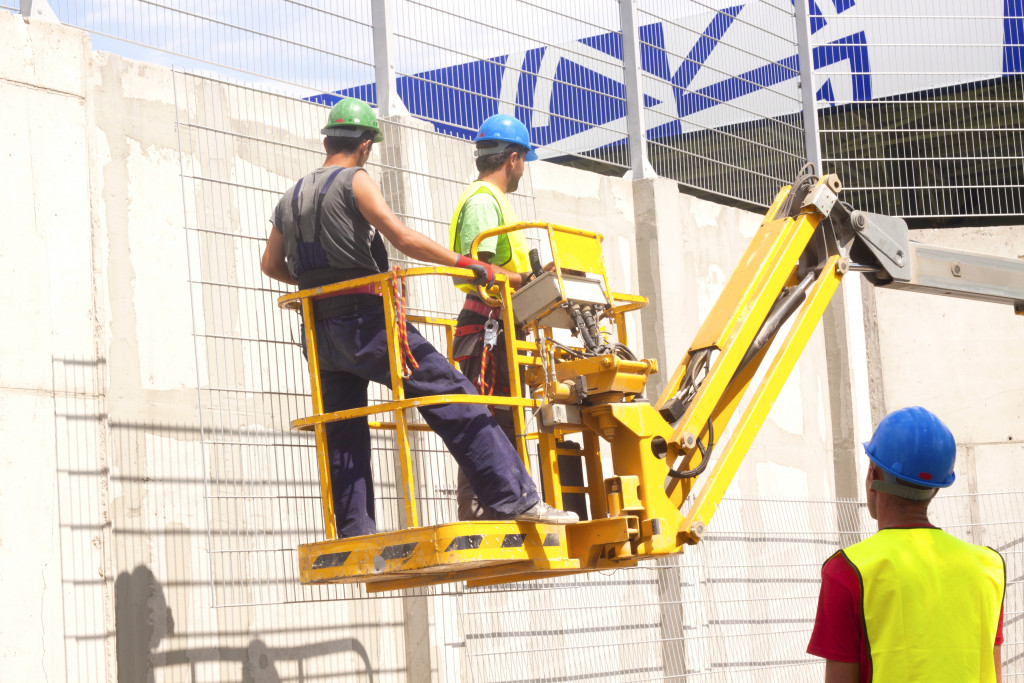 construction platform elevated towards a blue sky with construction workers