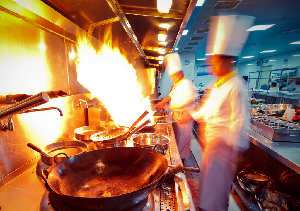 a shot of a kitchen with chefs cooking