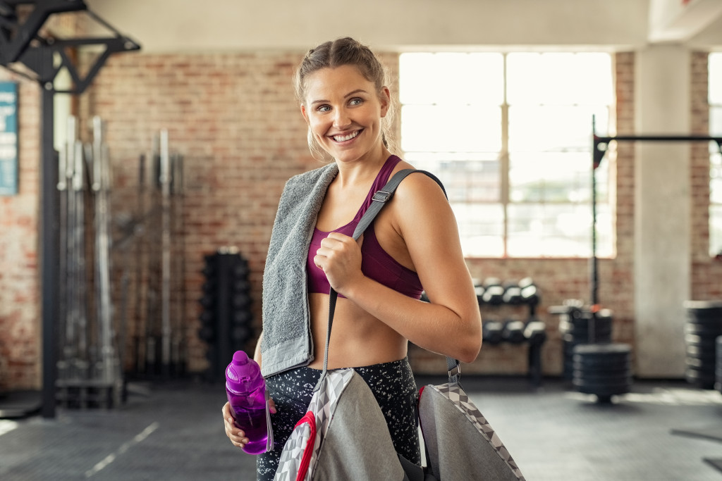 woman at the gym smiling after workout